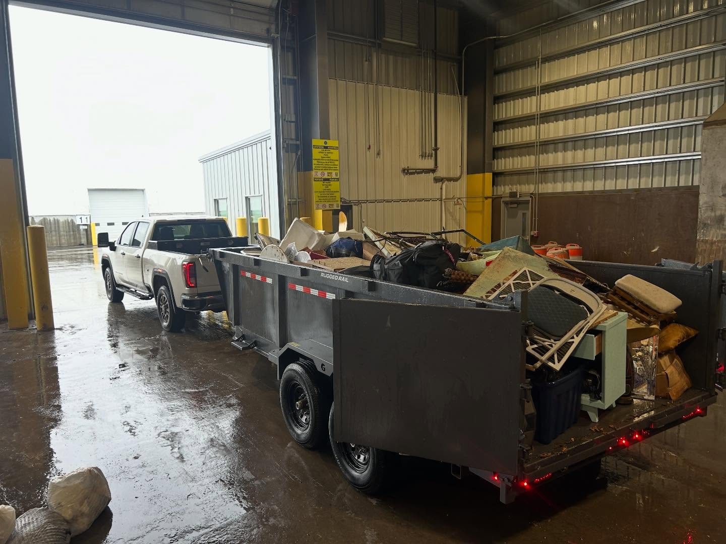 Dump trailer loaded with furniture and household junk at the transfer station